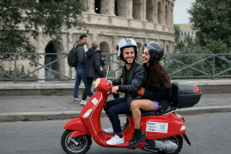 Couple riding Vespa in Rome